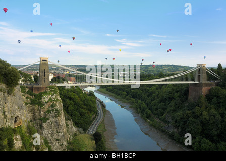 Bristol`s famous Clifton suspension bridge with a large number of hot air balloons flying past it during the 2009 Balloon fiesta Stock Photo